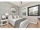 Bedroom featuring an accent wall, large framed art, and modern decor with large window at 11510 Quiet Forest Dr, Tampa, FL 33635