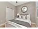 Bedroom featuring textured wallpaper, large mirror, with large closet doors at 11510 Quiet Forest Dr, Tampa, FL 33635