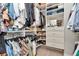 Well-organized walk-in closet with custom shelving, hanging rods, and shoe racks for optimal storage at 11510 Quiet Forest Dr, Tampa, FL 33635