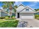 Charming single-Gathering home with a manicured lawn, blooming flowerbeds, and a two-car garage at 11510 Quiet Forest Dr, Tampa, FL 33635