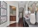 Hallway featuring wood floors, artwork, and arched doorways offering a glimpse into other rooms at 11510 Quiet Forest Dr, Tampa, FL 33635