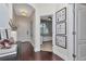 Light-filled foyer featuring wood flooring, decorative accents, and doorway to a bedroom at 11510 Quiet Forest Dr, Tampa, FL 33635