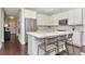 Modern kitchen with white cabinets, stainless steel appliances, and counter seating at 11510 Quiet Forest Dr, Tampa, FL 33635