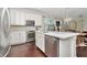 Bright kitchen boasts white cabinets, stainless steel appliances, and an island at 11510 Quiet Forest Dr, Tampa, FL 33635