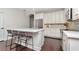 Stylish kitchen features white cabinets, stainless steel appliances and a center island at 11510 Quiet Forest Dr, Tampa, FL 33635