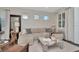 Inviting living room featuring three windows, comfortable seating, and tasteful decor at 11510 Quiet Forest Dr, Tampa, FL 33635