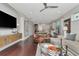Open-concept living room with seamless transition to a modern kitchen and dining area, filled with natural light at 11510 Quiet Forest Dr, Tampa, FL 33635