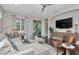 Comfortable living room with sliding glass doors, modern lighting and stylish decor at 11510 Quiet Forest Dr, Tampa, FL 33635