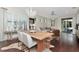 Bright living room featuring a modern chandelier, dining table and views through sliding glass doors at 11510 Quiet Forest Dr, Tampa, FL 33635