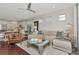 Spacious living room boasting modern decor, natural light, and an open flow to the dining and kitchen areas at 11510 Quiet Forest Dr, Tampa, FL 33635