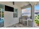 Charming outdoor kitchen with stainless steel grill, mini fridge, and storage, great for entertaining at 11510 Quiet Forest Dr, Tampa, FL 33635