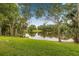 A lake sits behind the property, surrounded by lush grass and mature trees at 11816 Raintree Lake Ln # B, Tampa, FL 33617