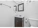 Bathroom features a dark vanity and framed mirror with towel bar at 11816 Raintree Lake Ln # B, Tampa, FL 33617