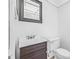 Compact bathroom features a dark vanity and framed mirror at 11816 Raintree Lake Ln # B, Tampa, FL 33617