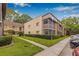Exterior angle view of condo building with well maintained green lawn at 11816 Raintree Lake Ln # B, Tampa, FL 33617