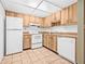 Kitchen with tile flooring, wooden cabinets and white appliances at 11816 Raintree Lake Ln # B, Tampa, FL 33617
