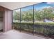 Screened lanai offers a peaceful view of the surrounding landscaping at 11816 Raintree Lake Ln # B, Tampa, FL 33617