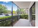 Screened patio overlooking parking area and mature landscaping at 11816 Raintree Lake Ln # B, Tampa, FL 33617