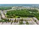 An aerial view shows the community's layout, highlighting green spaces and proximity to natural wooded area at 11839 Castine St, New Port Richey, FL 34654