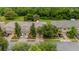 Aerial view of a tan two-story townhome with manicured lawns and trees at 11839 Castine St, New Port Richey, FL 34654