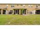 Home backyard with grassy space, a small tree, and a screened patio area at 11839 Castine St, New Port Richey, FL 34654