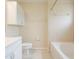 Bright bathroom featuring a shower-tub combo, tile flooring, and ample cabinet space at 11839 Castine St, New Port Richey, FL 34654