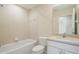 Bathroom features shower-tub combo and single sink vanity with tiled flooring at 11839 Castine St, New Port Richey, FL 34654