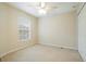 Carpeted bedroom featuring natural light and a closet at 11839 Castine St, New Port Richey, FL 34654