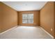 Bedroom with neutral carpet and warm painted walls with natural light from the window at 11839 Castine St, New Port Richey, FL 34654