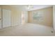 Spacious bedroom features neutral tones, plush carpet, and a view of the outside at 11839 Castine St, New Port Richey, FL 34654