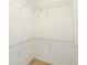 Large, carpeted walk-in closet with installed wire shelving for easy storage at 11839 Castine St, New Port Richey, FL 34654