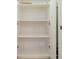 Uncluttered empty closet features white walls and shelving, offering plenty of storage at 11839 Castine St, New Port Richey, FL 34654