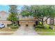 Townhome exterior with two-car garages, mature trees, and well-maintained landscaping at 11839 Castine St, New Port Richey, FL 34654