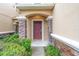Inviting entryway with stone pillars, detailed trim, and lush landscaping at 11839 Castine St, New Port Richey, FL 34654