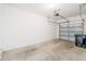 Spacious two car garage with concrete floors, with the garage door slightly open at 11839 Castine St, New Port Richey, FL 34654