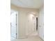 Upstairs hallway featuring carpet, and white walls leading to bedrooms and bathrooms at 11839 Castine St, New Port Richey, FL 34654