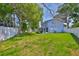 Expansive backyard featuring a lush green lawn and mature trees at 12468 Empire Dr, Seminole, FL 33772