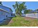 Spacious backyard with ample lawn space and a screened-in porch at 12468 Empire Dr, Seminole, FL 33772