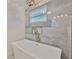 Modern bathroom showcases a freestanding tub, window, and stylish tile work at 12468 Empire Dr, Seminole, FL 33772