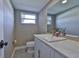 Cozy half-bathroom with a modern vanity, stylish finishes, and natural light at 12468 Empire Dr, Seminole, FL 33772