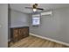 Bedroom with wood floors, ceiling fan, AC, and a wooden dresser with ornate detailing at 12468 Empire Dr, Seminole, FL 33772