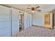 Bright bedroom with wood floors, ceiling fan, and sliding door closet with mirrors at 12468 Empire Dr, Seminole, FL 33772