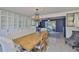 Elegant dining room with a chandelier, a built-in cabinet, a large dining table and views to the living room at 12468 Empire Dr, Seminole, FL 33772