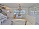 Elegant dining room with a chandelier, a built-in cabinet, a large dining table and views to the front yard at 12468 Empire Dr, Seminole, FL 33772
