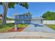 Charming two-story home features a well-manicured lawn, a long driveway, and a two-car garage at 12468 Empire Dr, Seminole, FL 33772