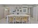 Open kitchen featuring a large island, great lighting, and access to exterior door at 12468 Empire Dr, Seminole, FL 33772