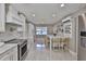 Open concept kitchen with stainless appliances, breakfast bar, and lots of counter space at 12468 Empire Dr, Seminole, FL 33772