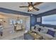 Living room and dining room combo featuring tile floors, ceiling fan and coastal decor at 12468 Empire Dr, Seminole, FL 33772
