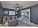 Comfortable living room with blue walls, a ceiling fan, cozy seating, and access to the outdoor patio at 12468 Empire Dr, Seminole, FL 33772