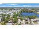 A high aerial view showcasing a home near a lake, enveloped by lush trees and adjacent residences at 12803 126Th Ter, Largo, FL 33774